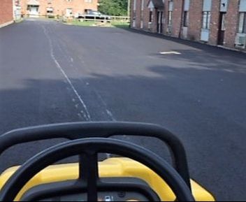 Compacting Asphalt in a Parking Lot NC Paving Pros Raleigh, NC